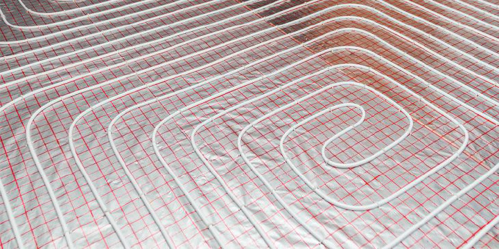 Underfloor heating pipes laid out on floor slab prior to screed application